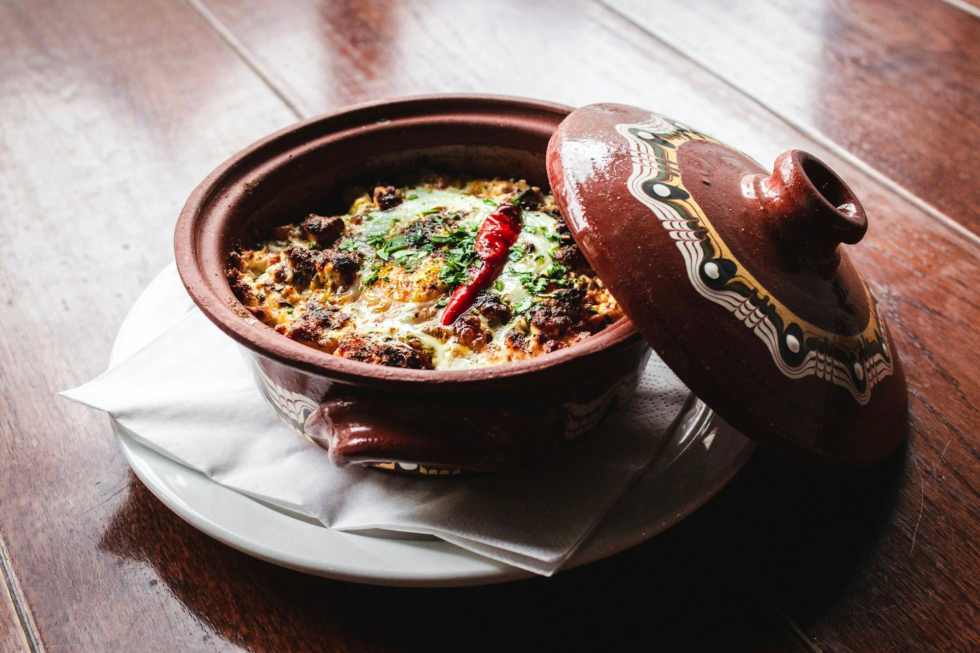 Biriyani in a clay pot with its lid lifted