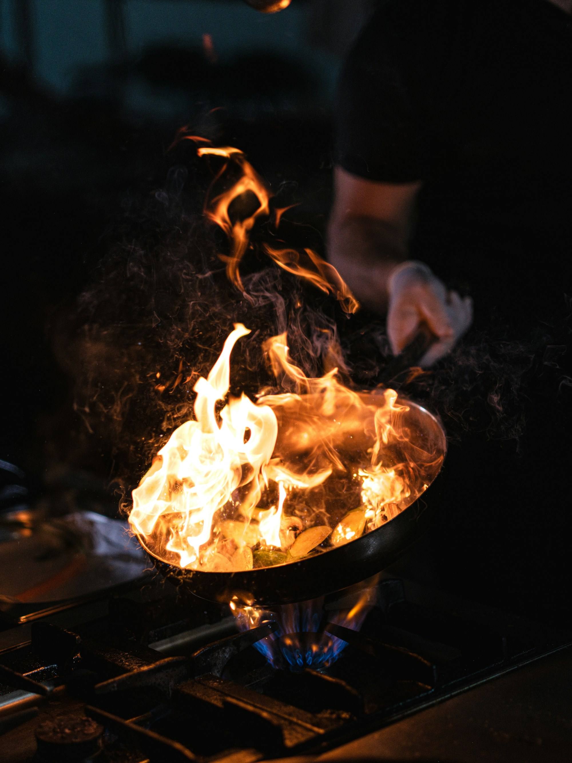 A pan held over a high flame
